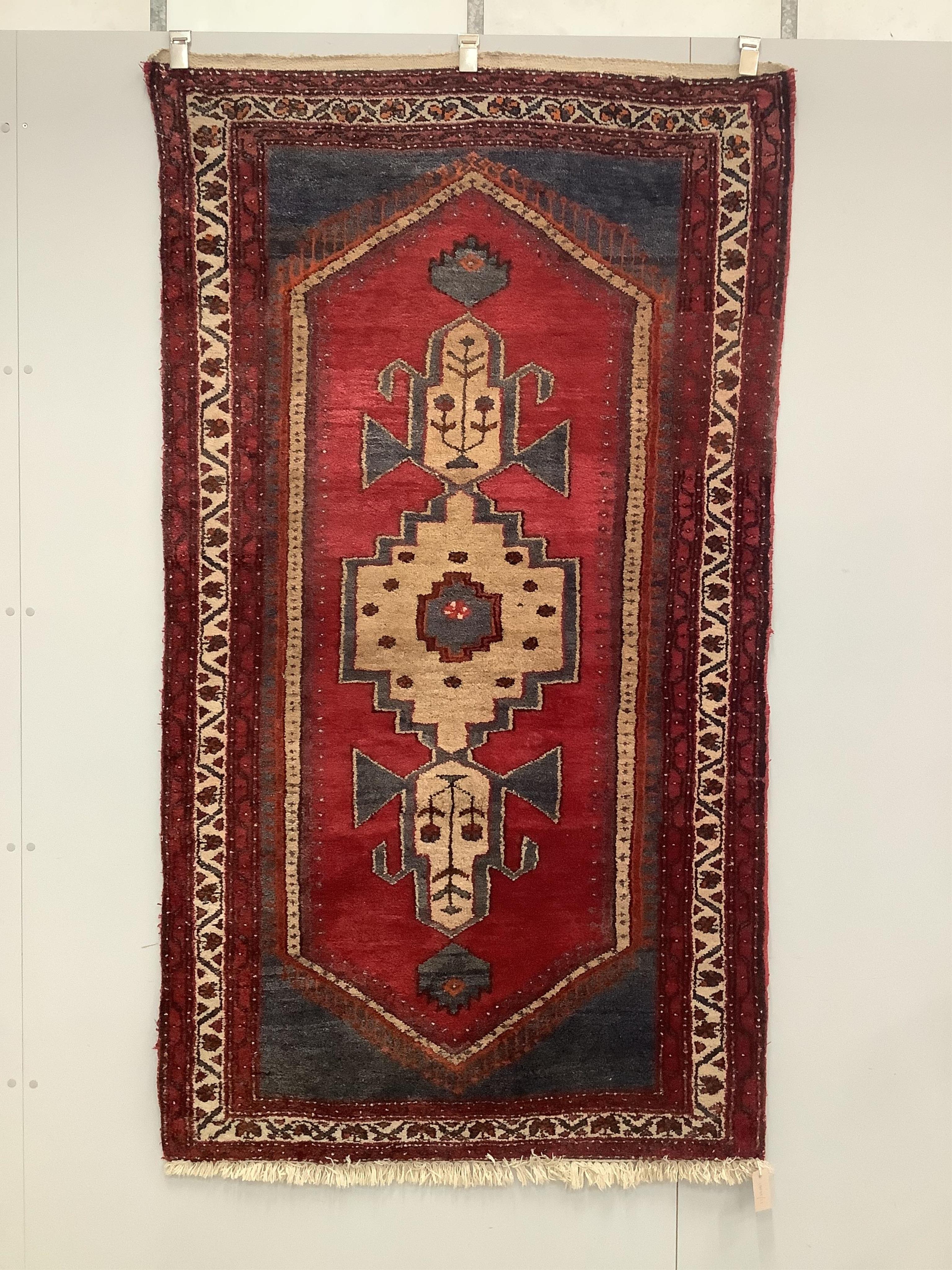 A Caucasian style red ground rug, 200 x 110cm. Condition - fair